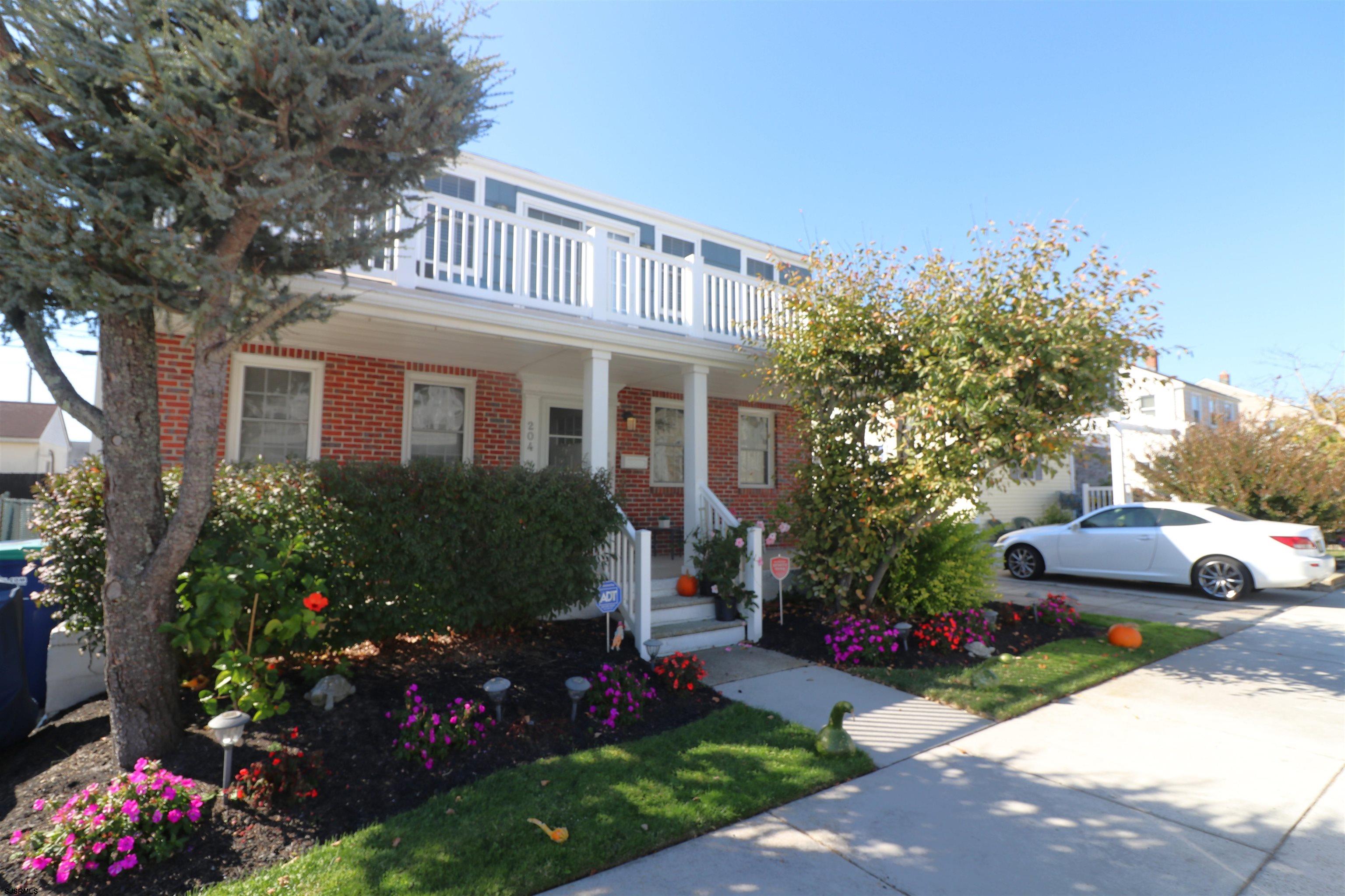 a front view of a house with a yard and fountain