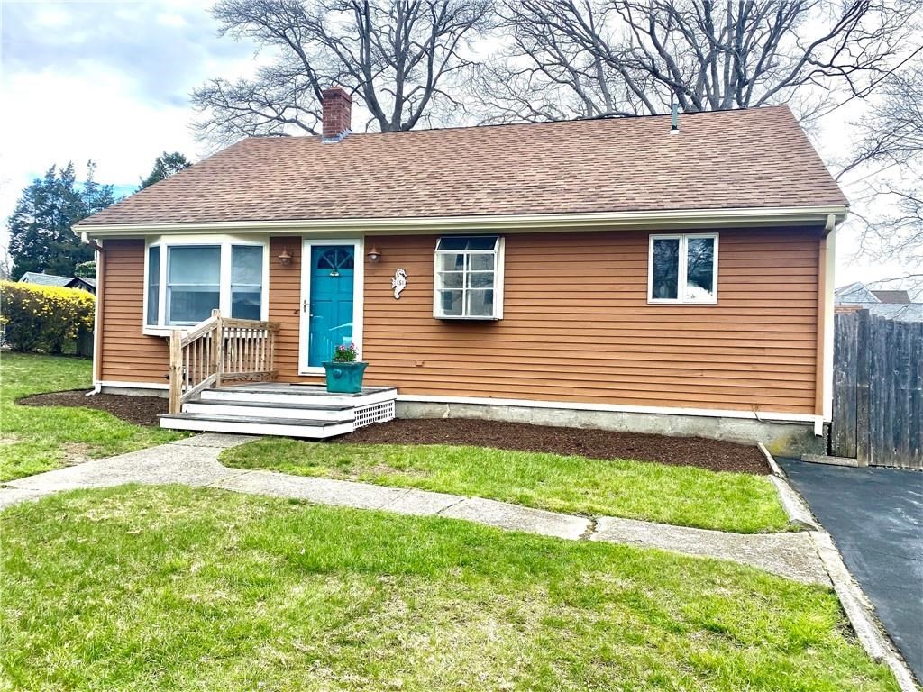 a front view of a house with a garden and yard