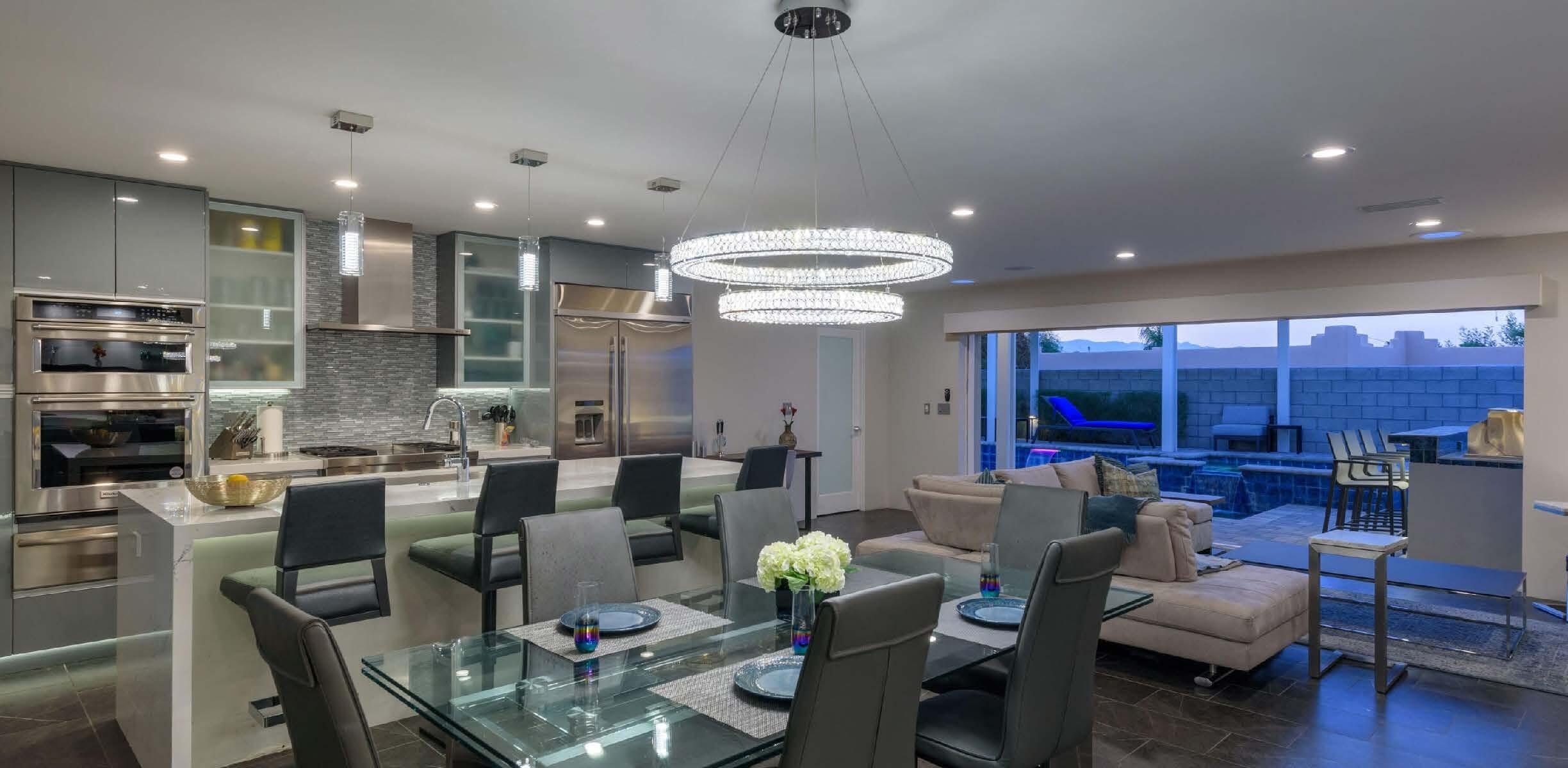 a living room with lots of furniture and view of kitchen