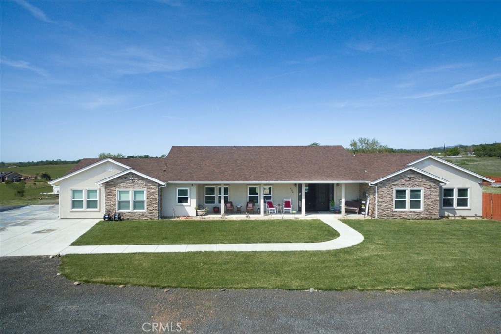 a front view of a house with a garden and yard