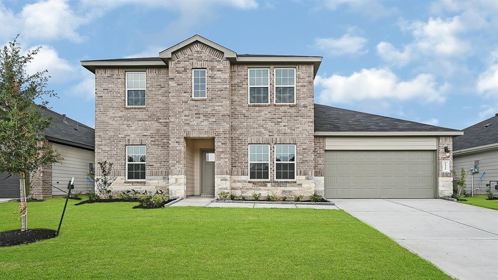 a front view of a house with a yard and garage