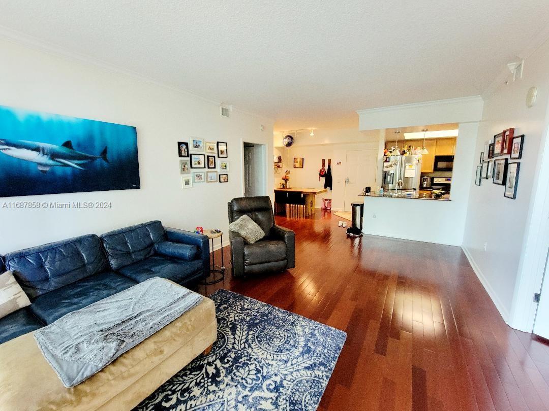 a living room with furniture and wooden floor