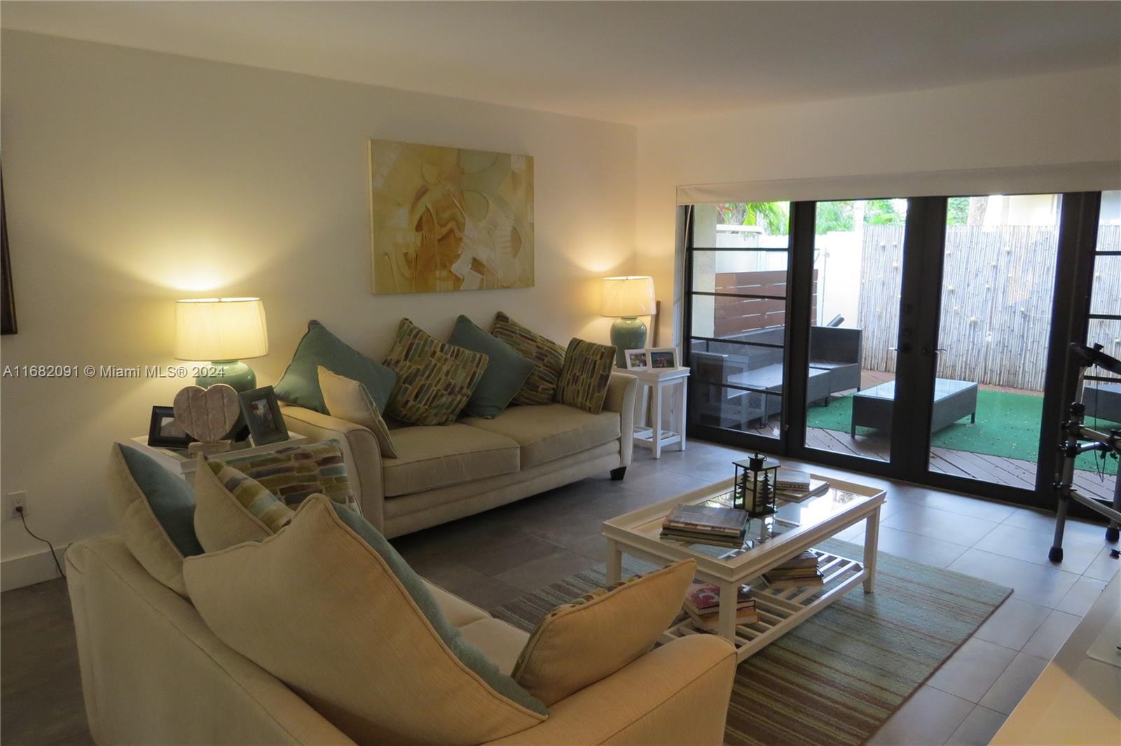 a living room with furniture and a floor to ceiling window