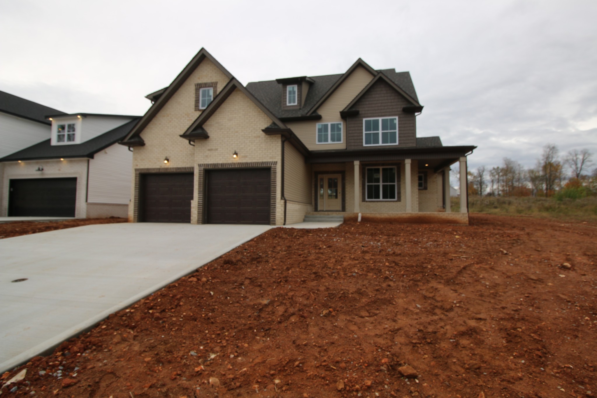 a front view of a house with a garden