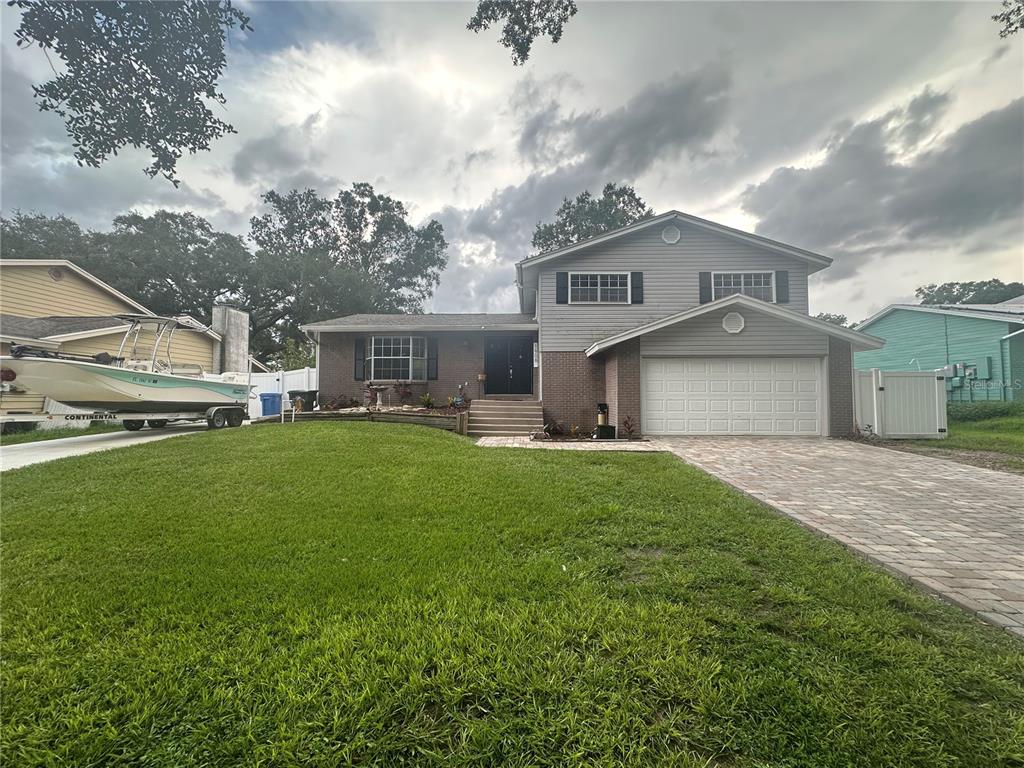 a front view of a house with a yard and garage