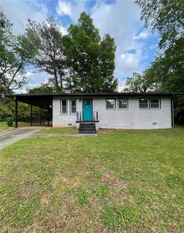 a front view of house with yard and outdoor seating