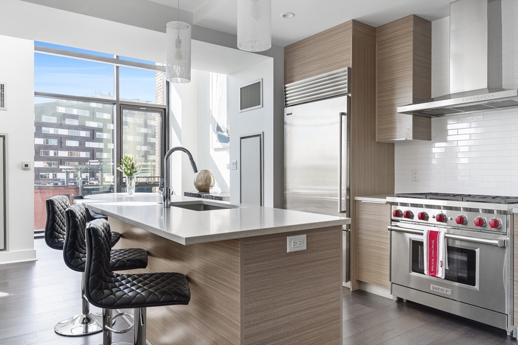 a kitchen with a stove a sink and a refrigerator