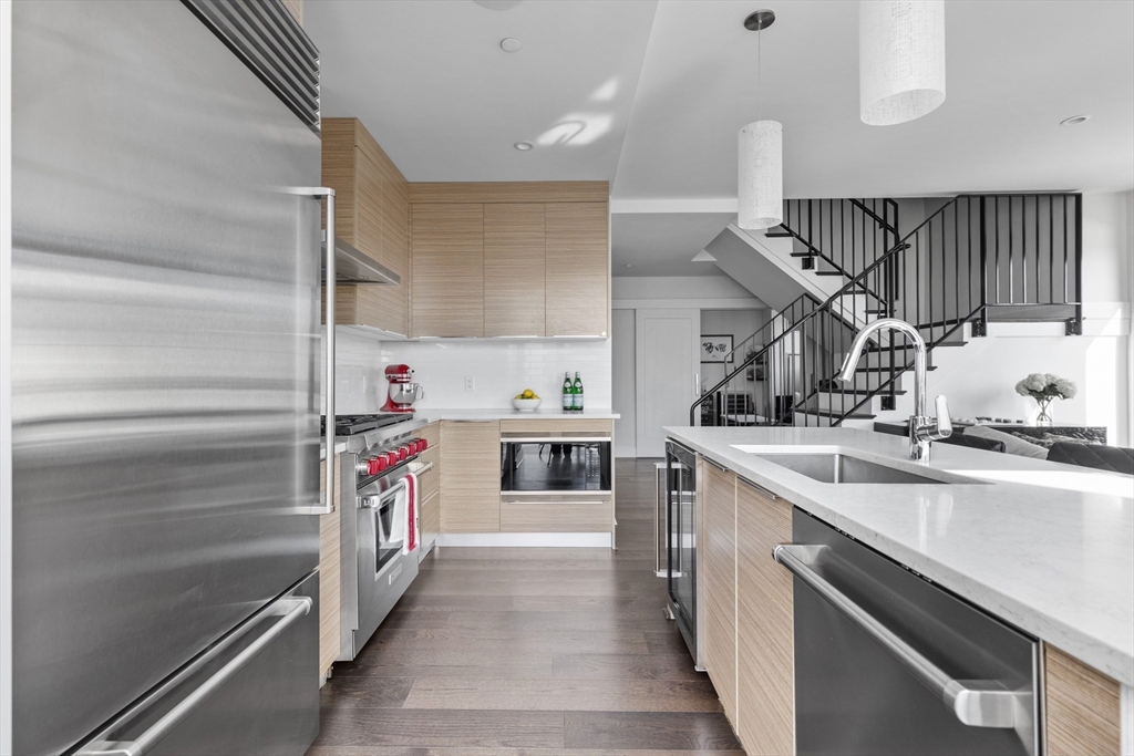 a kitchen with a sink and a stove top oven