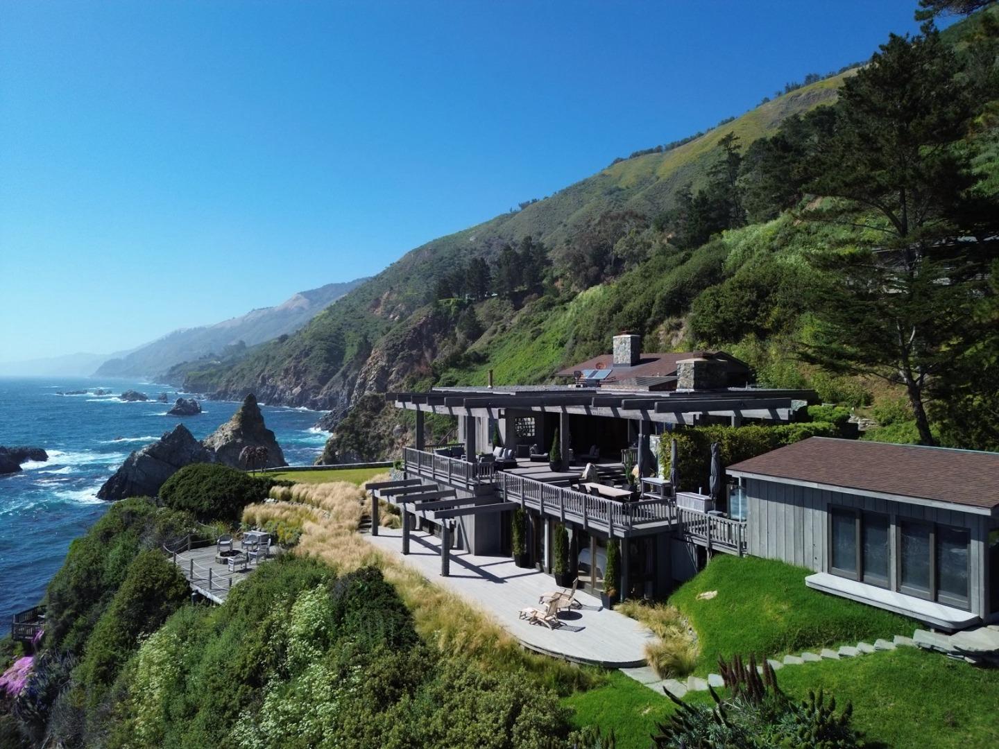 an aerial view of a house with swimming pool patio and lake view