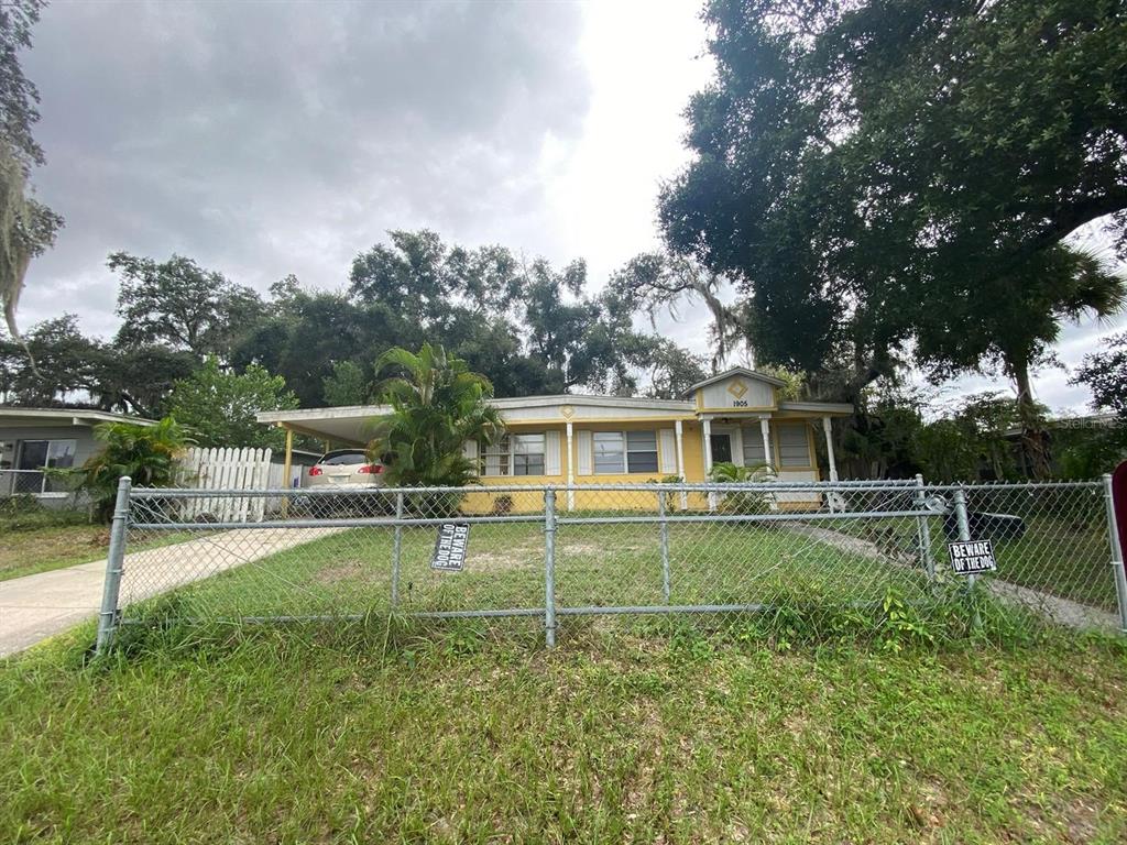 a view of a house with a yard and sitting area