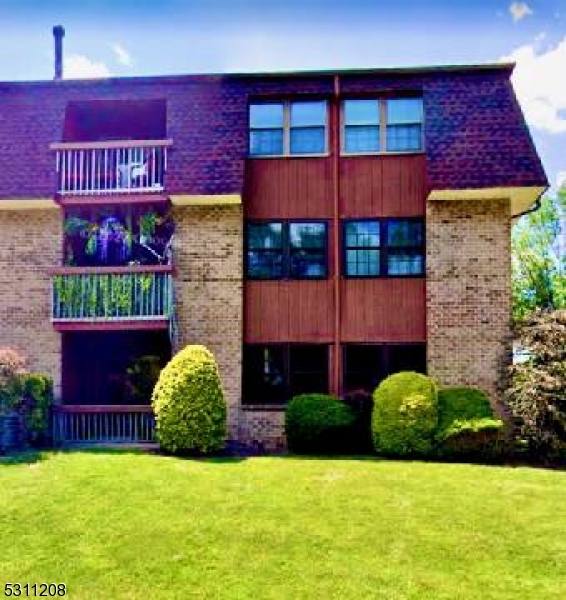 a view of a brick building with a yard