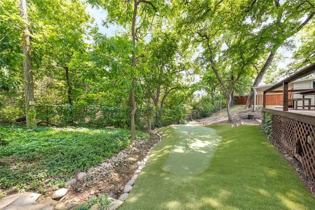 a view of a yard with large trees