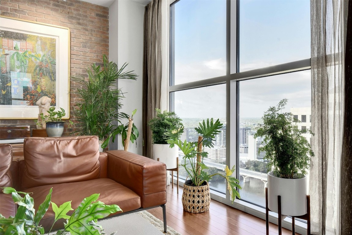 a living room with furniture and a potted plant