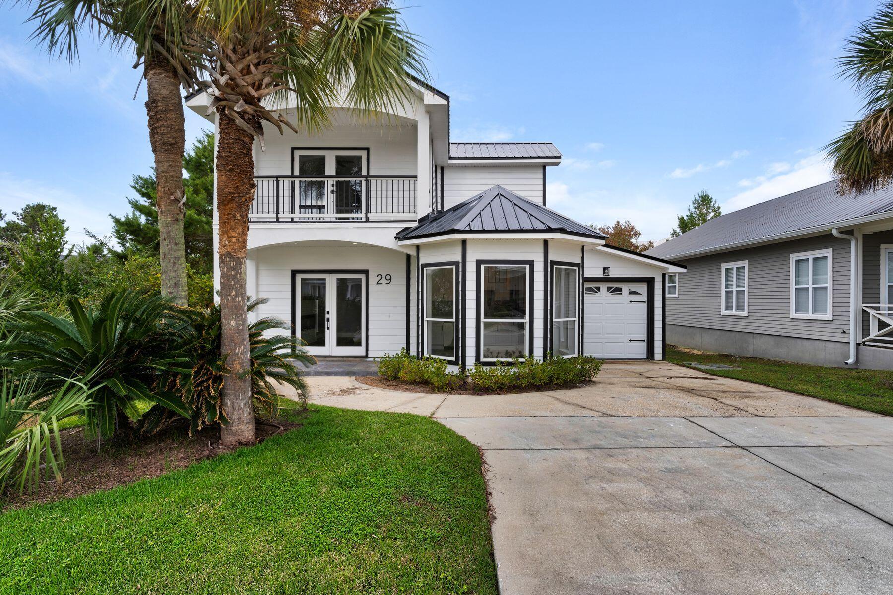 a front view of a house with a garden and yard