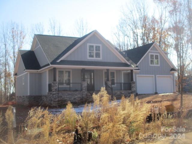 a front view of a house with a yard covered in snow