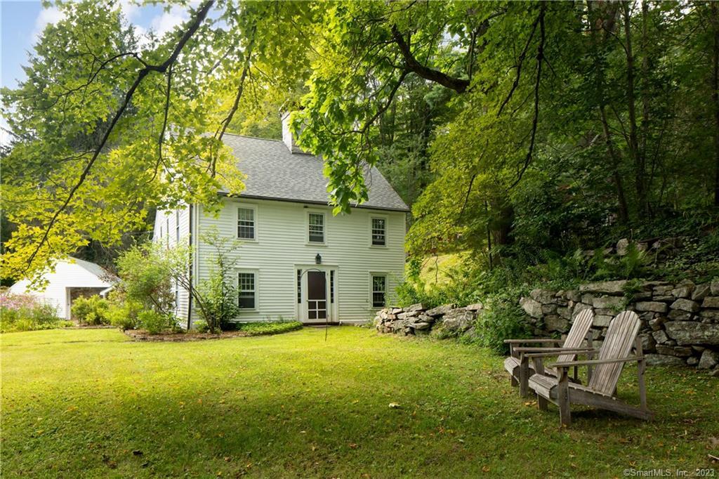 a view of a house with backyard and sitting area