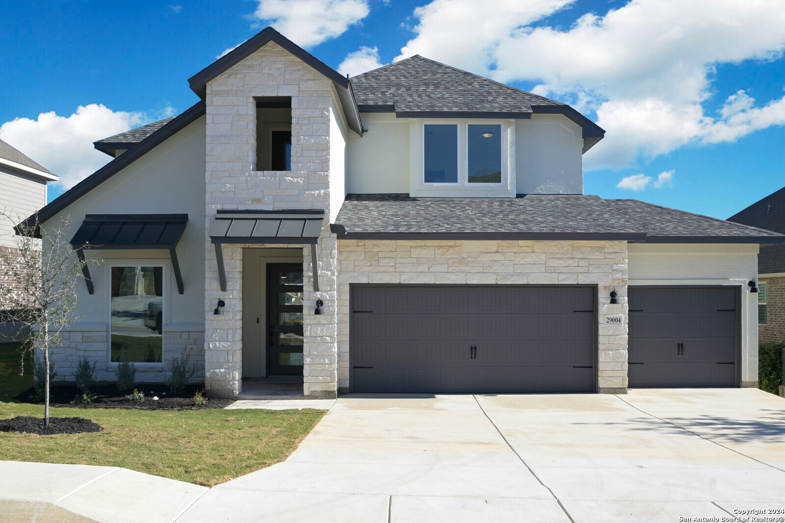 a front view of a house with a yard and garage