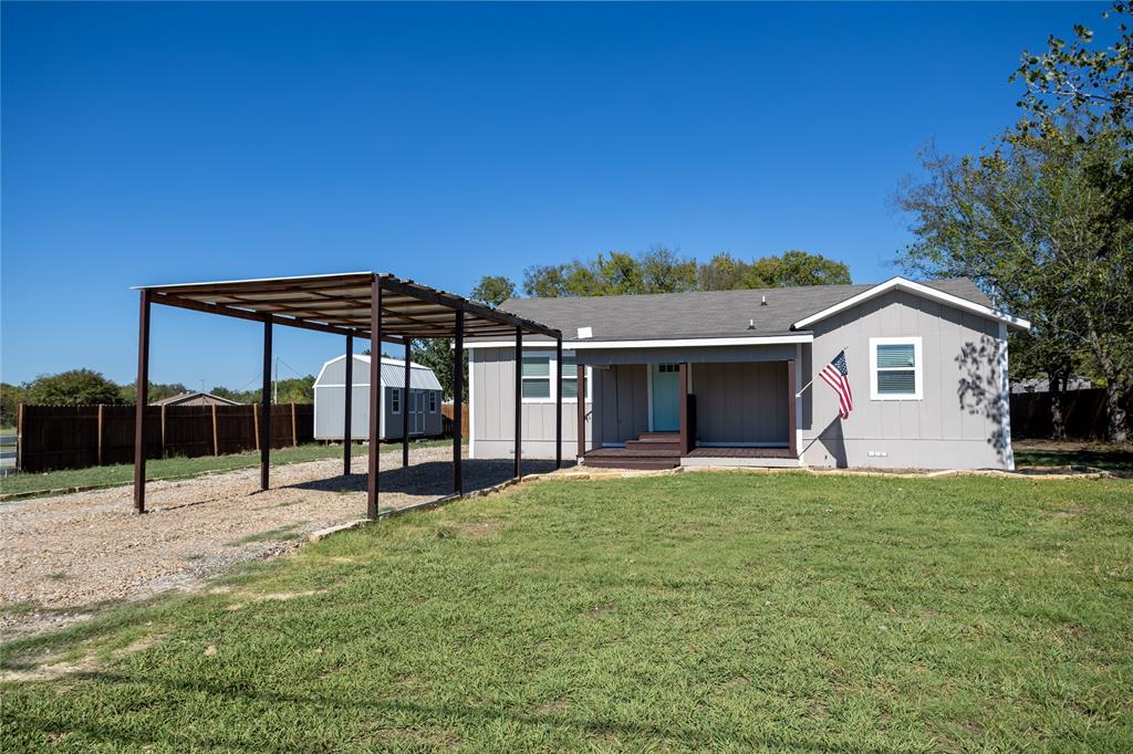 a view of a house with backyard and porch