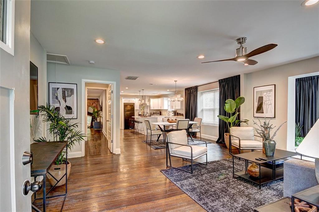 a living room with furniture rug and wooden floor