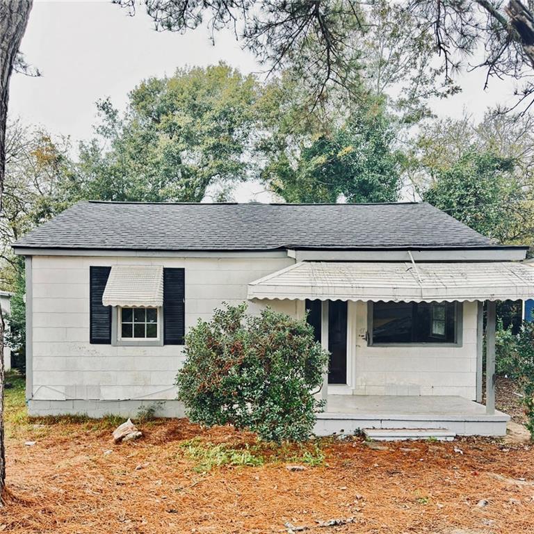 a house that has a tree in front of it