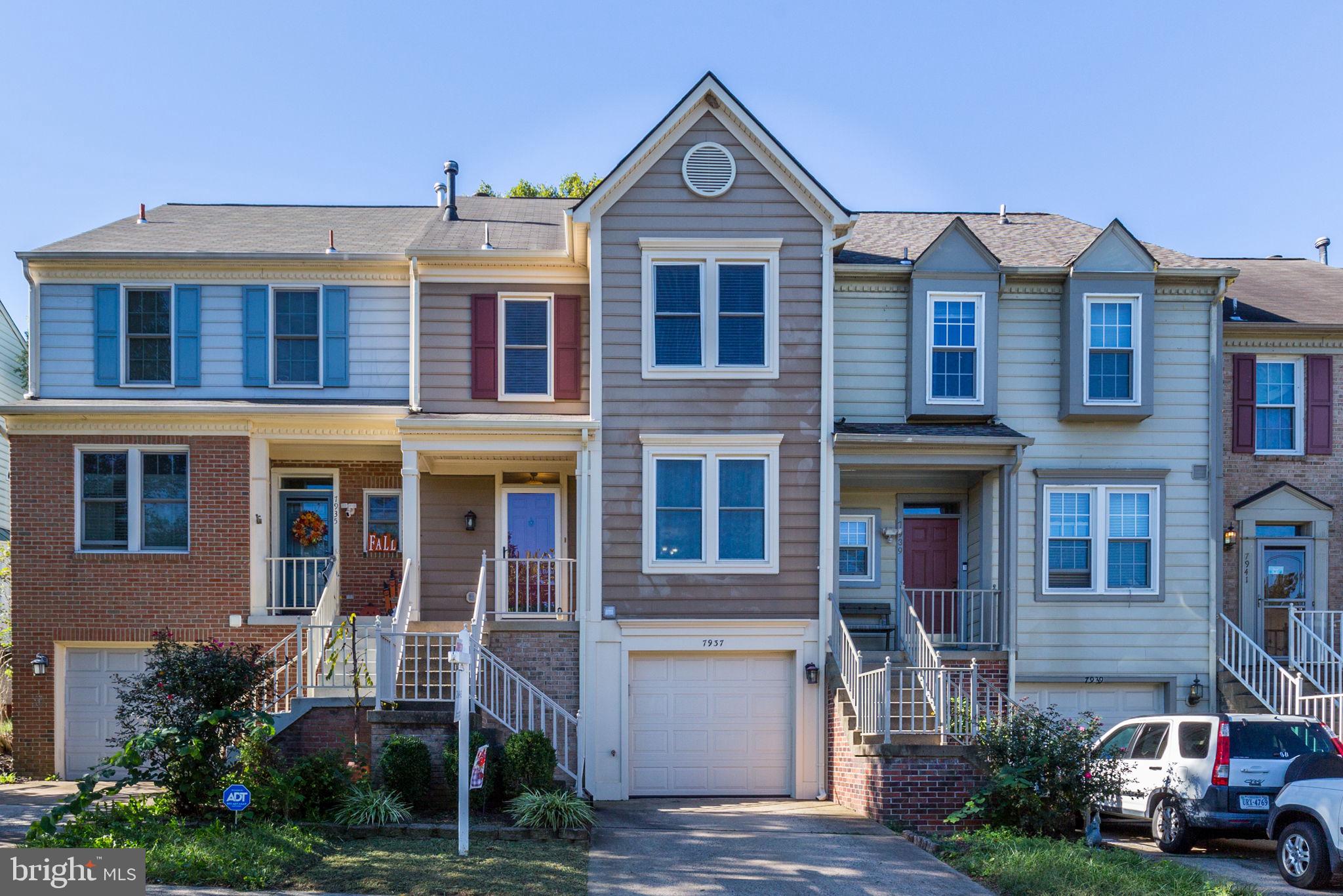 a front view of a residential apartment building with a yard