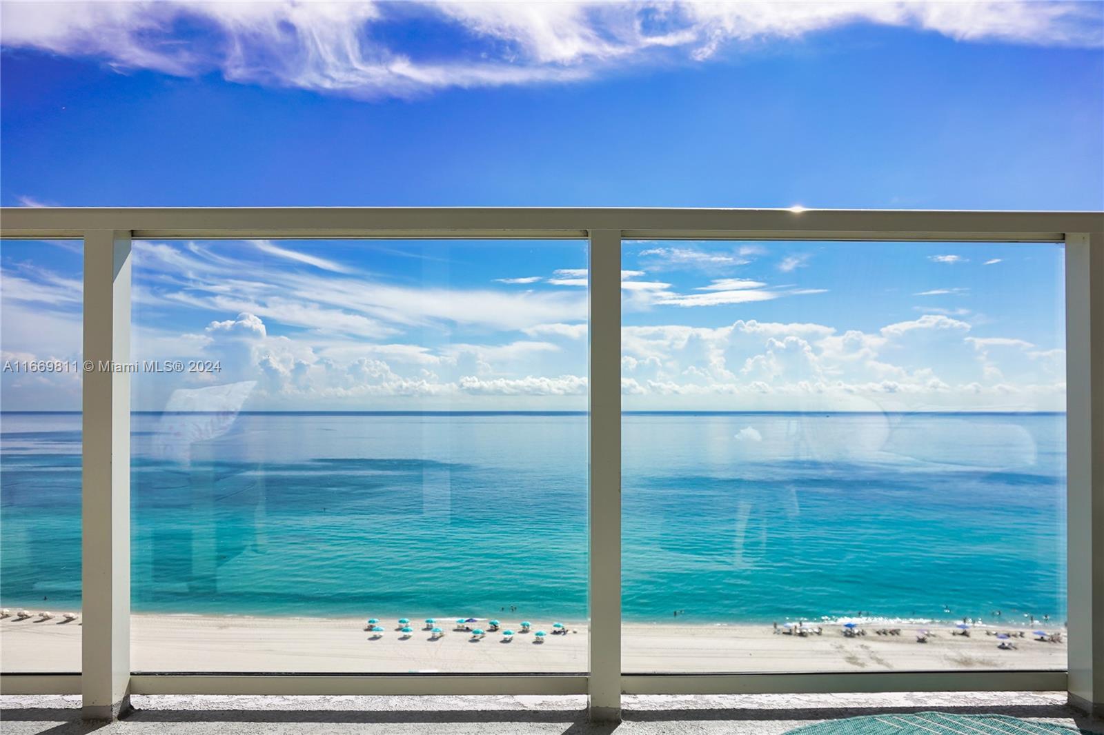 a view of a glass door with a yard