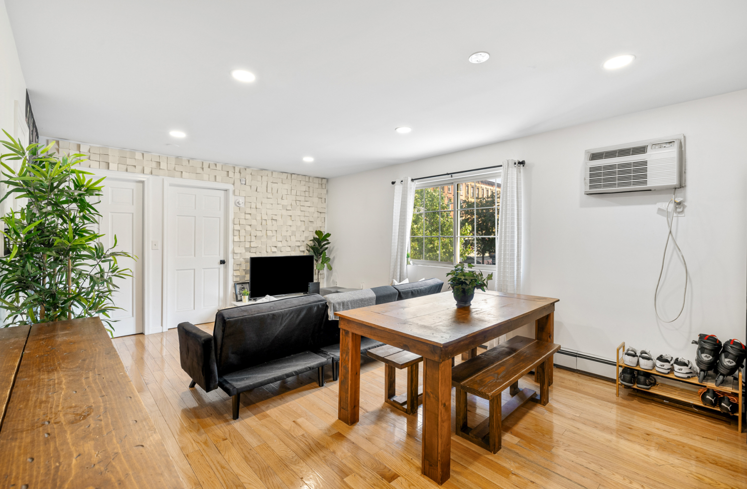 a living room with furniture and a potted plant