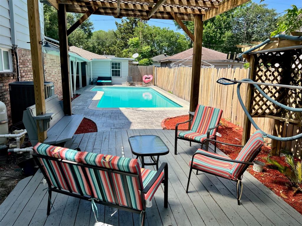 a view of a chairs and table in patio with wooden fence