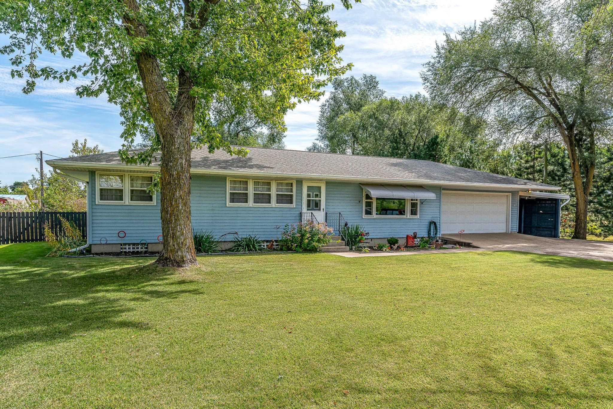 a front view of house with yard and green space