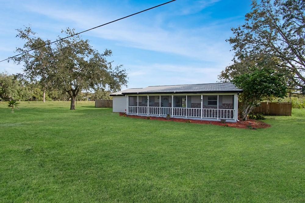 a view of a house with a backyard