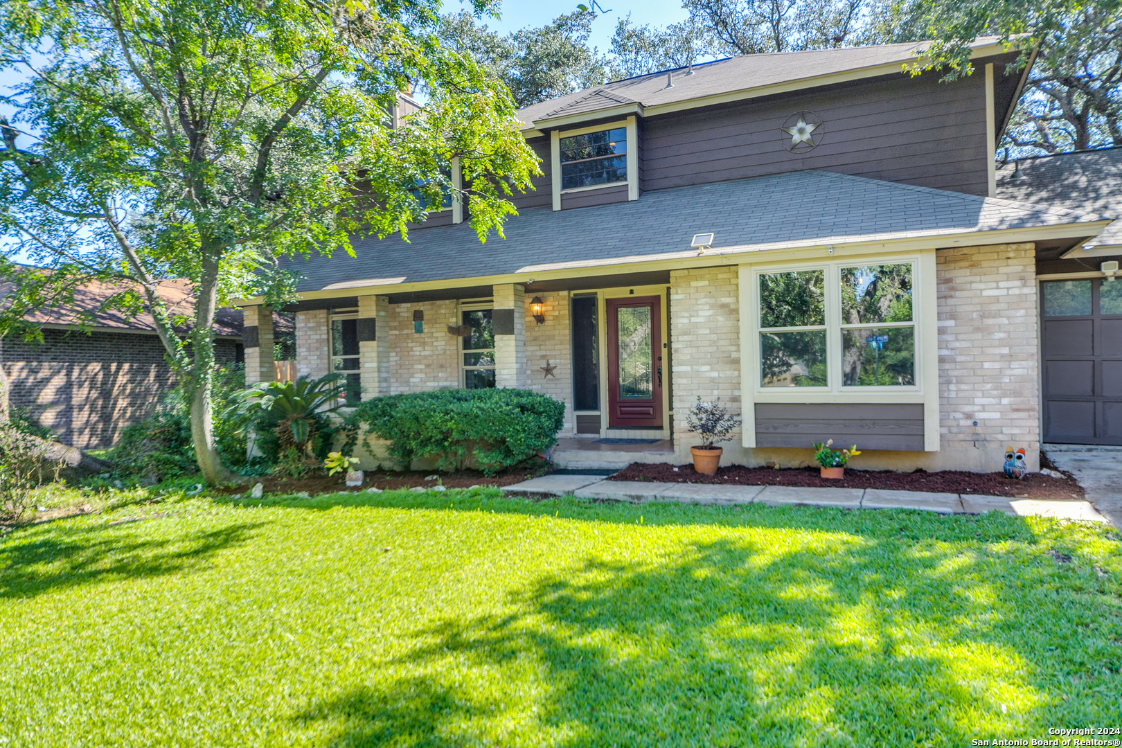 a view of house with yard and outdoor seating