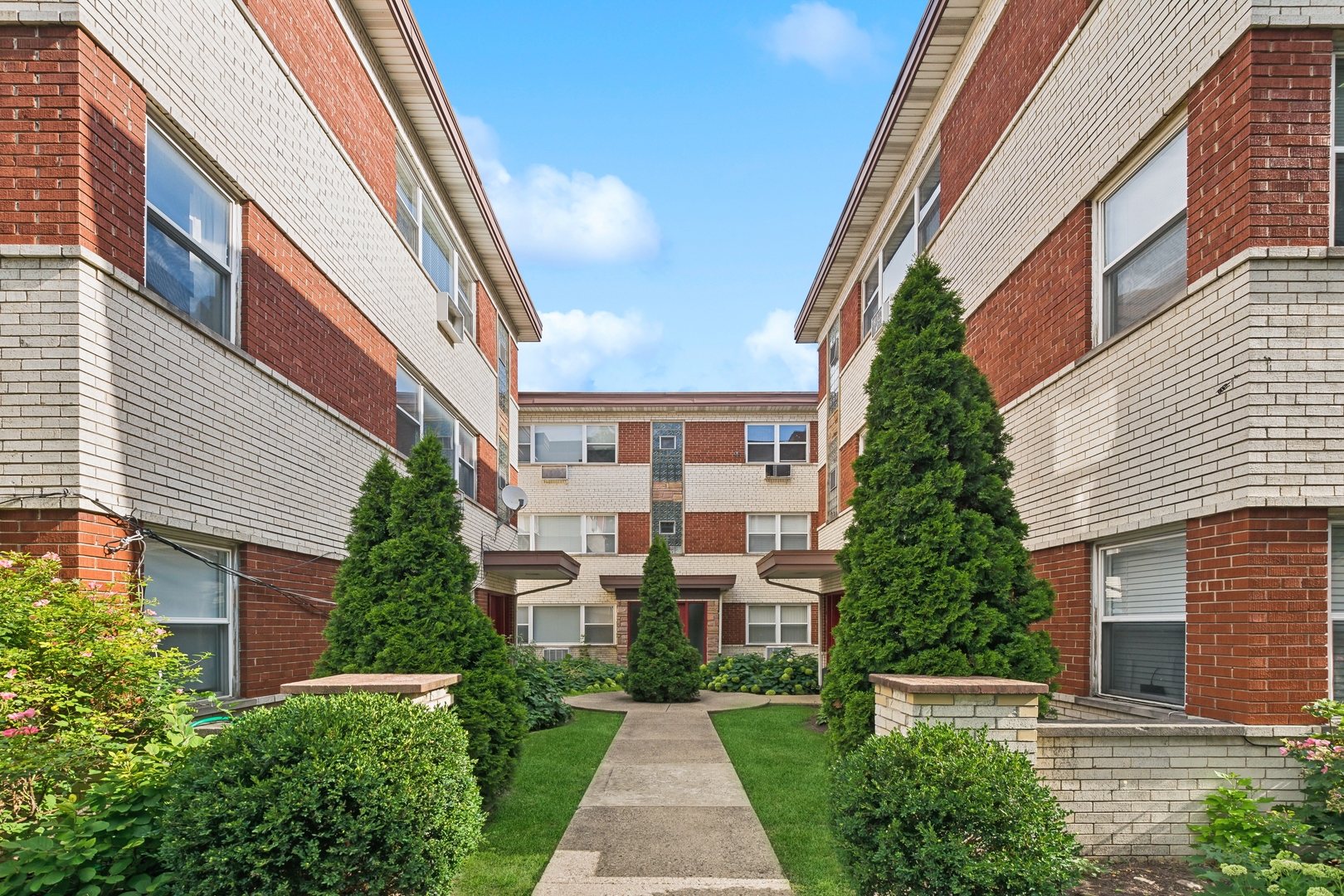 a view of a brick building next to a yard