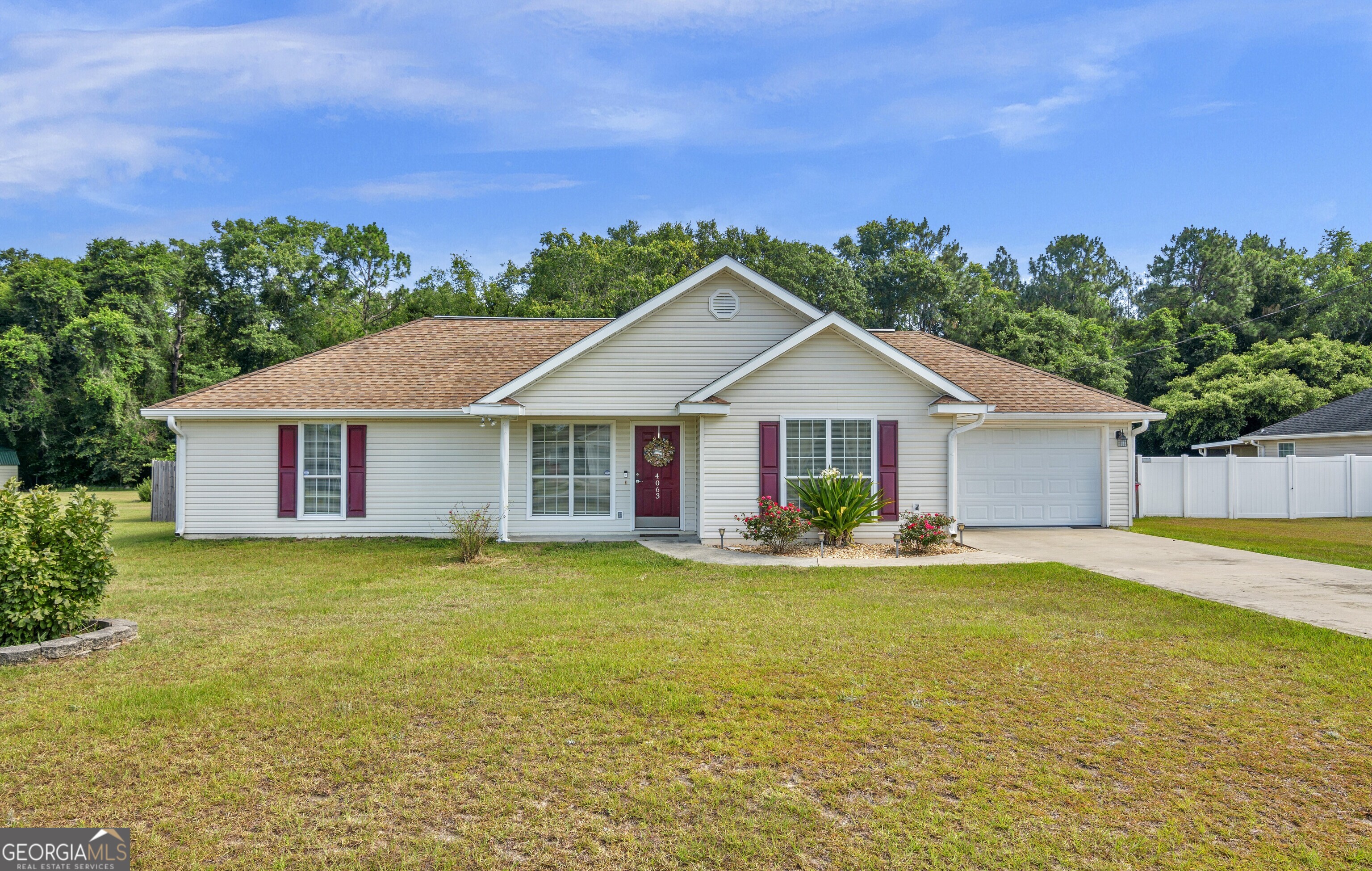 a front view of a house with a yard and trees