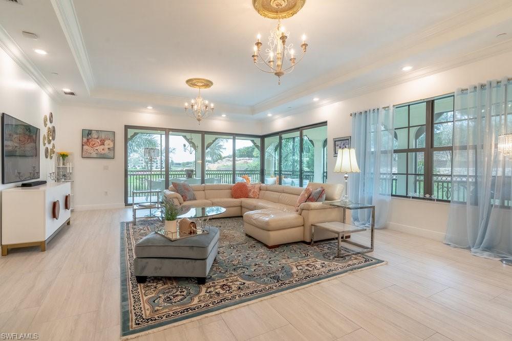 a living room with furniture and a chandelier