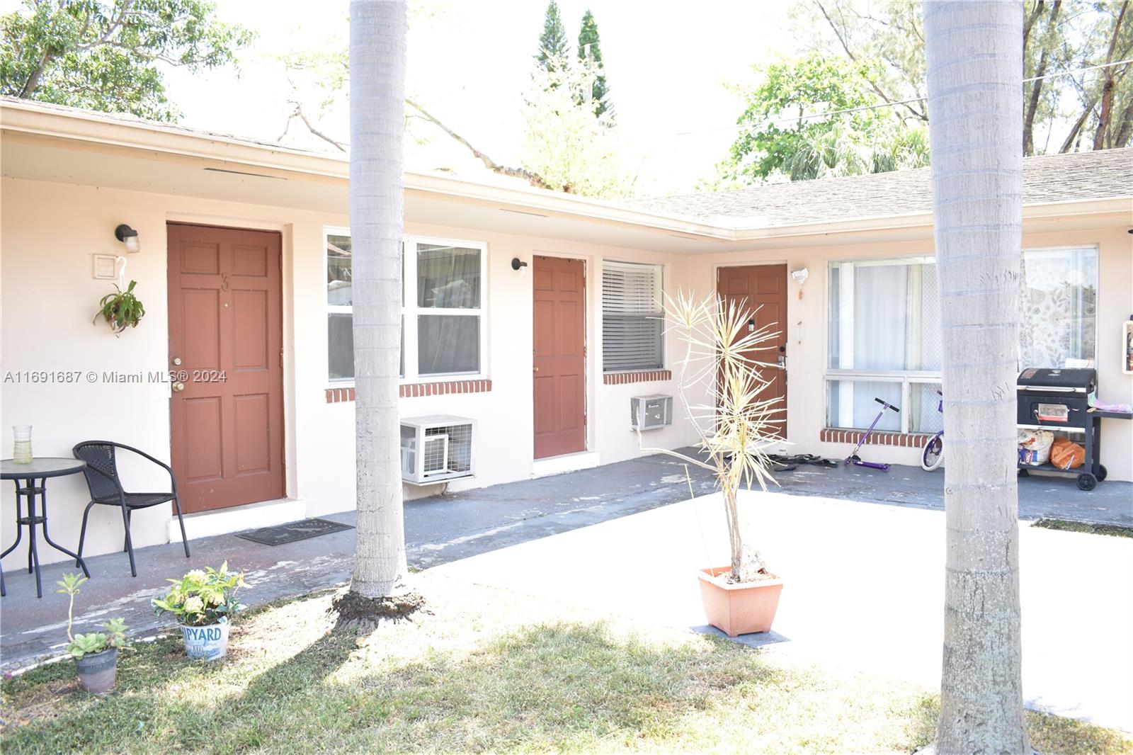 a front view of a house with outdoor seating