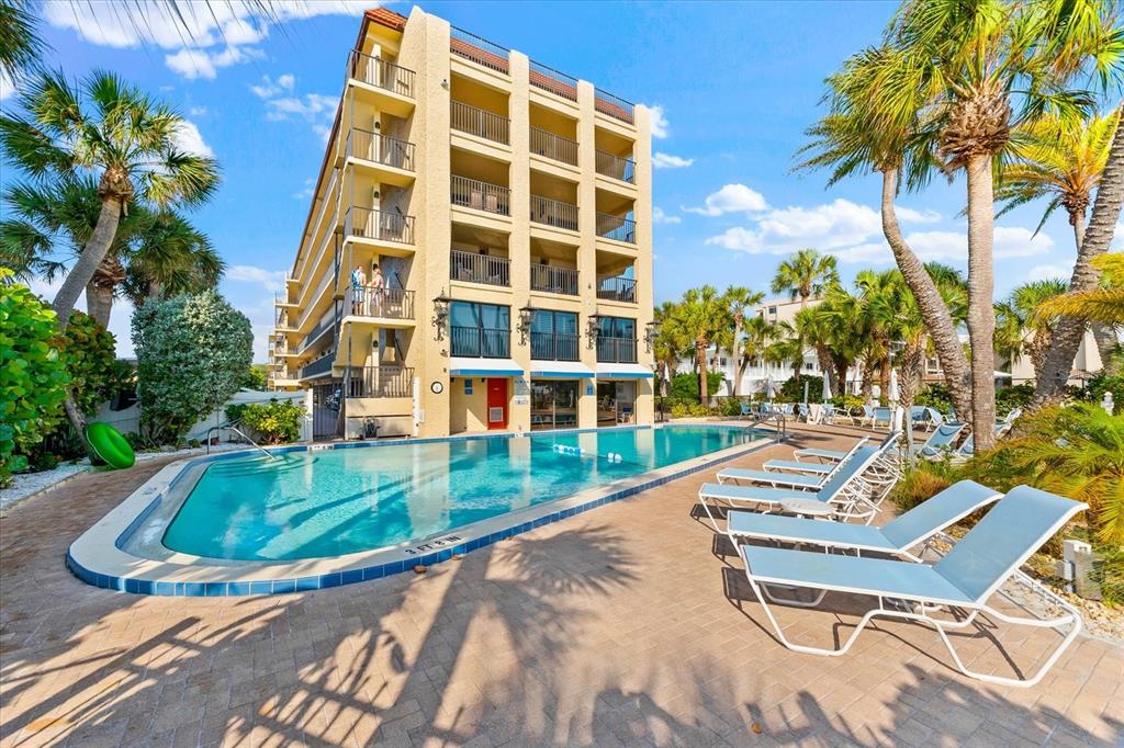 a view of swimming pool with a lounge chairs