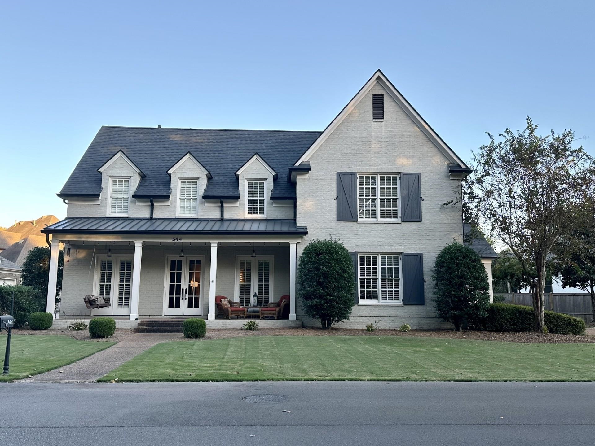 a front view of a house with a yard