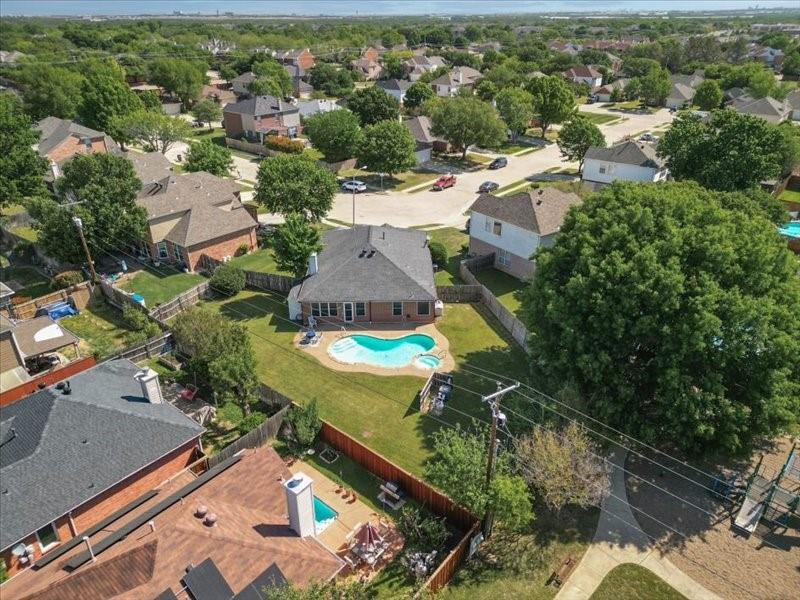 an aerial view of residential houses with outdoor space