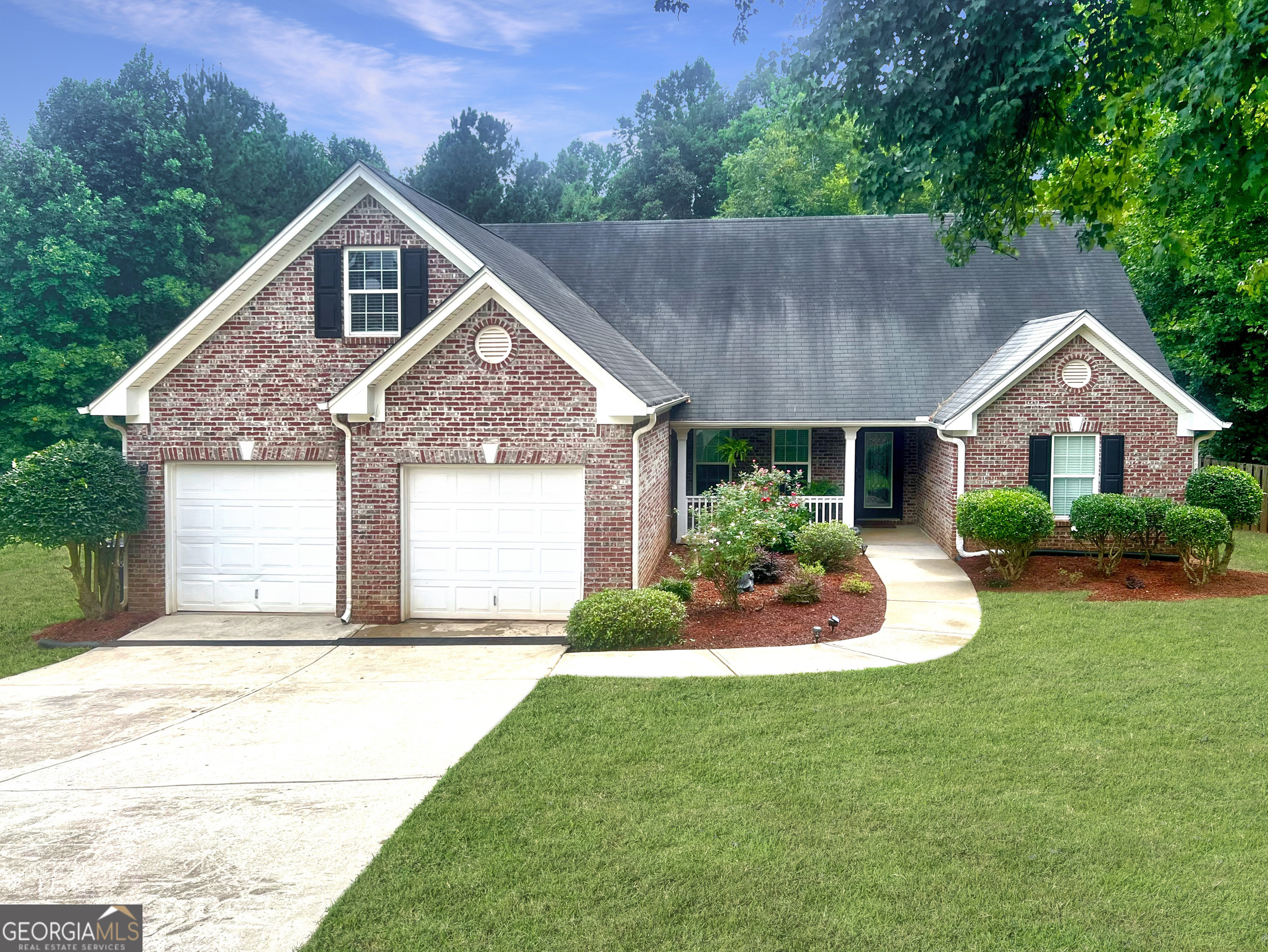 a front view of a house with a yard and garage