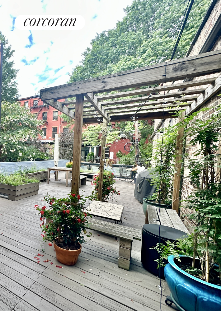 a living room with patio furniture and a potted plant