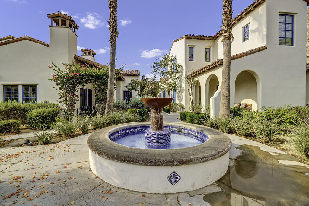 a view of a house with backyard swimming pool and sitting area