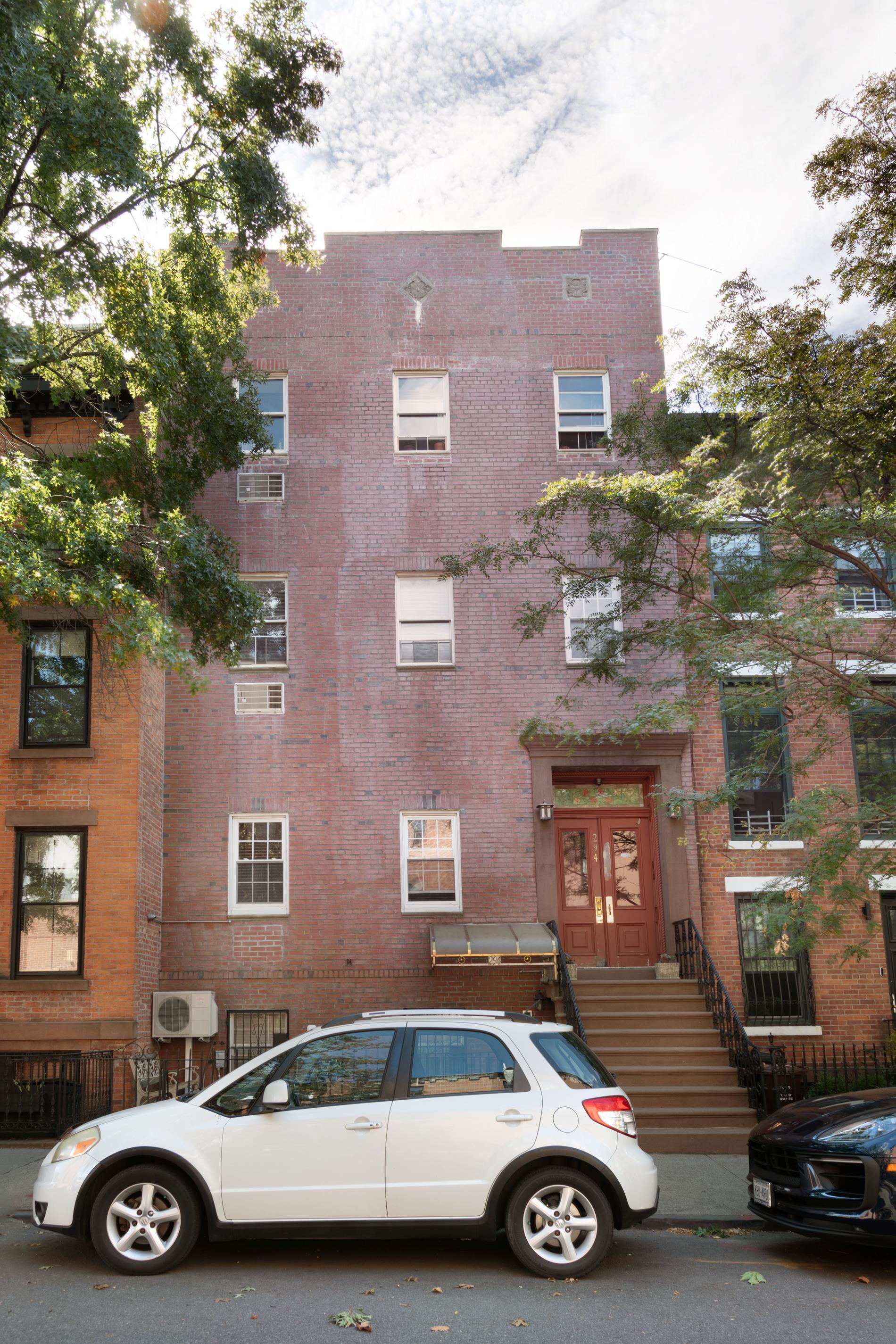 a car parked in front of a brick building