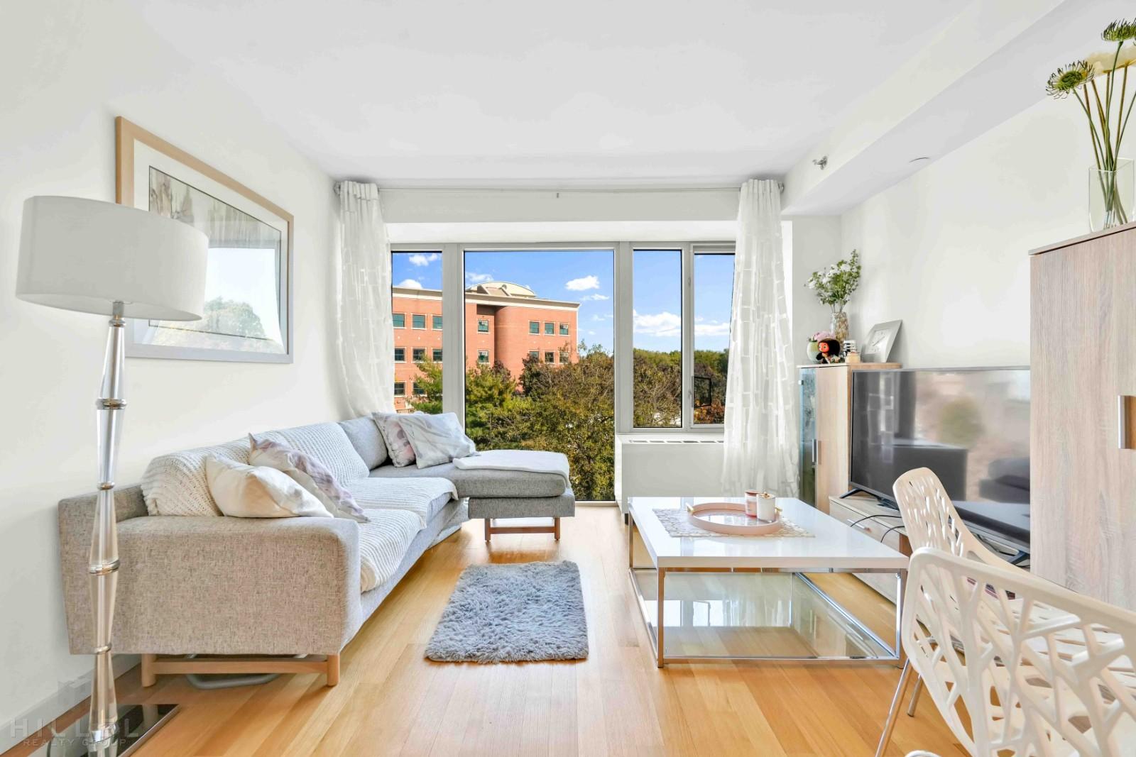 a living room with furniture wooden floor and a table