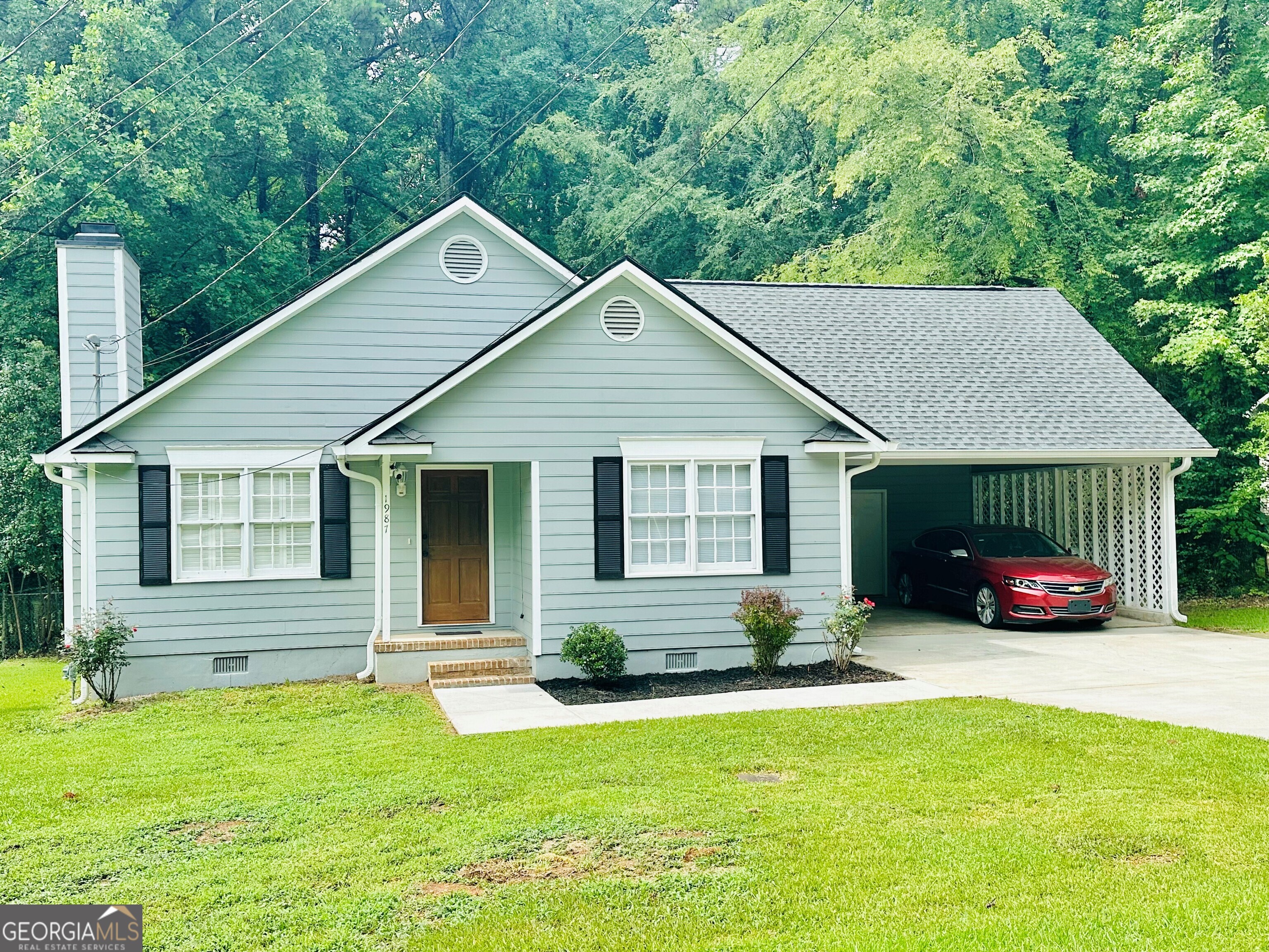 a front view of house with yard and green space