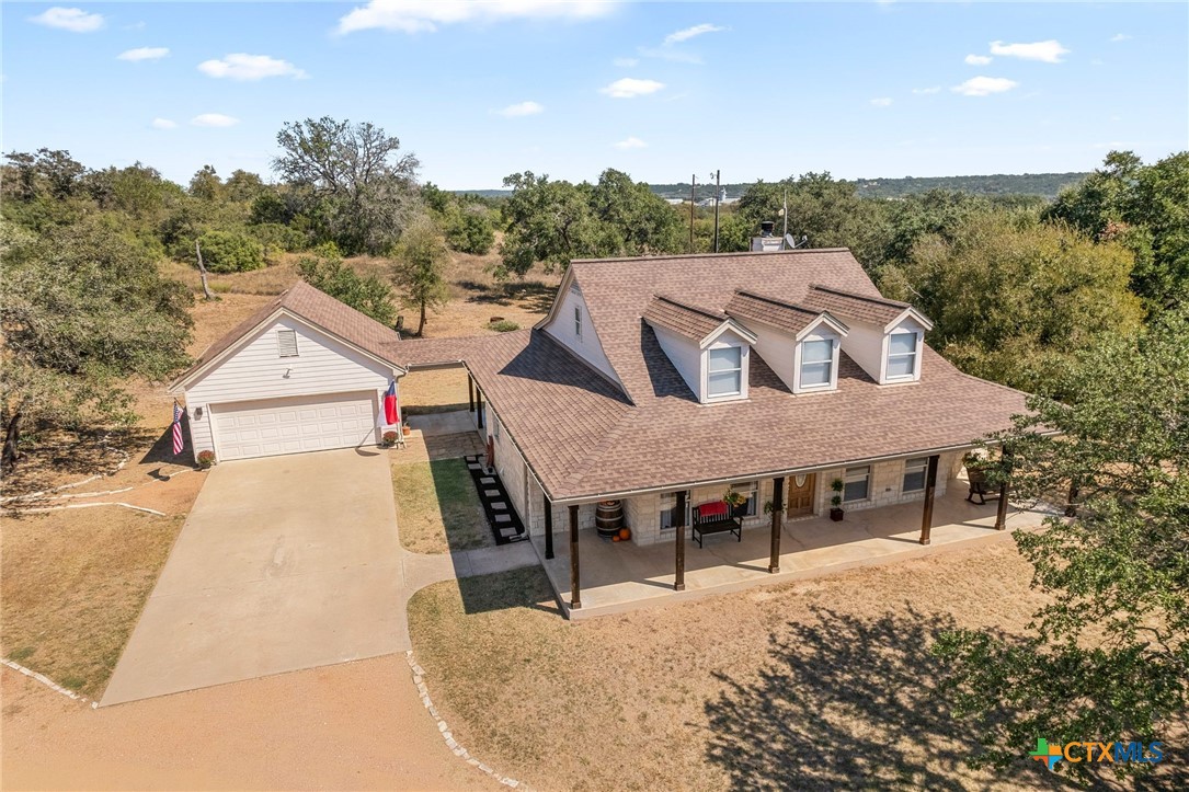 an aerial view of a house with yard porch and furniture