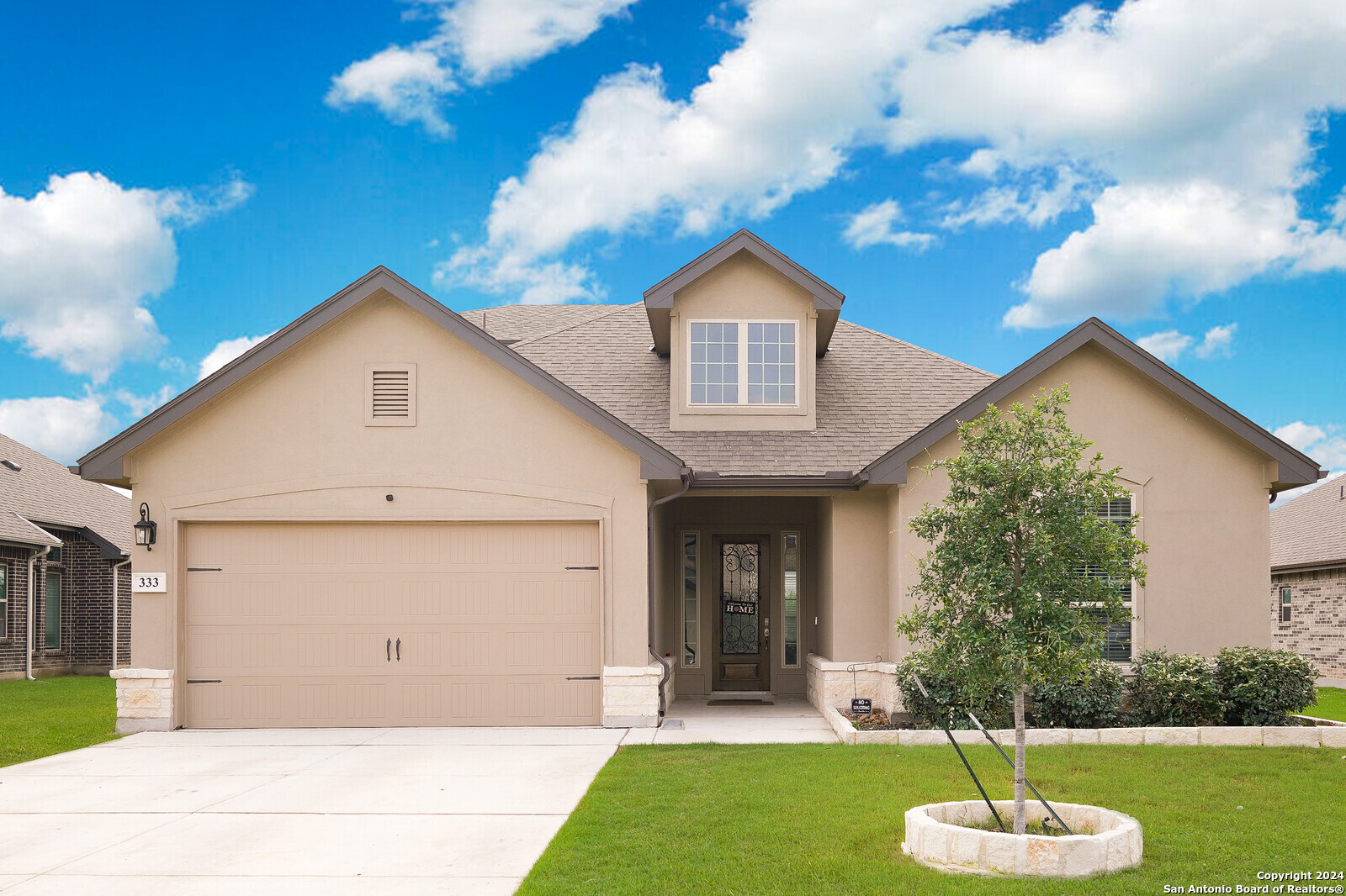 a front view of a house with a yard