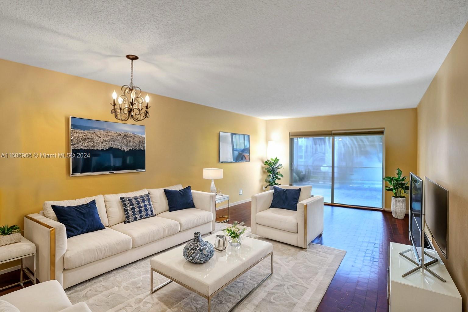 a living room with furniture a dining table and a window