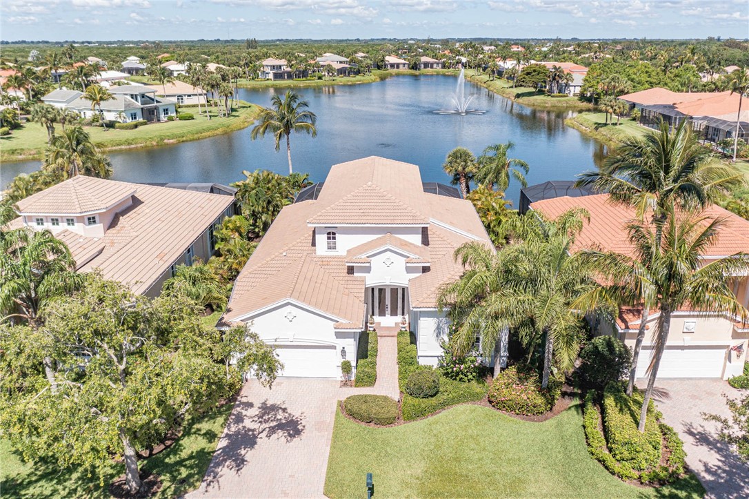 an aerial view of a house with outdoor space and lake view