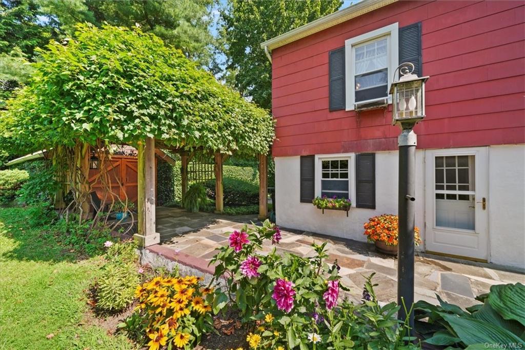 a front view of a house with a yard and fountain