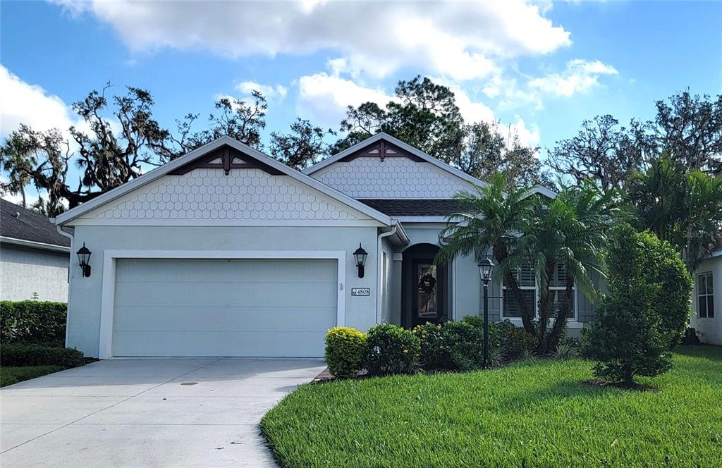 a front view of a house with a yard and garage